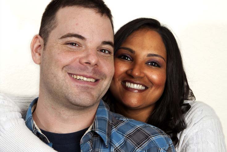 A man and woman smiling