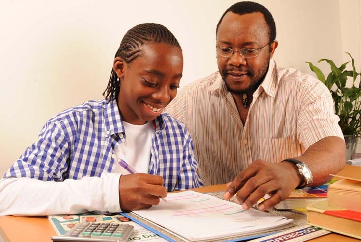 Man helping boy with homework